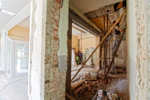 Image of workman stripping house interior